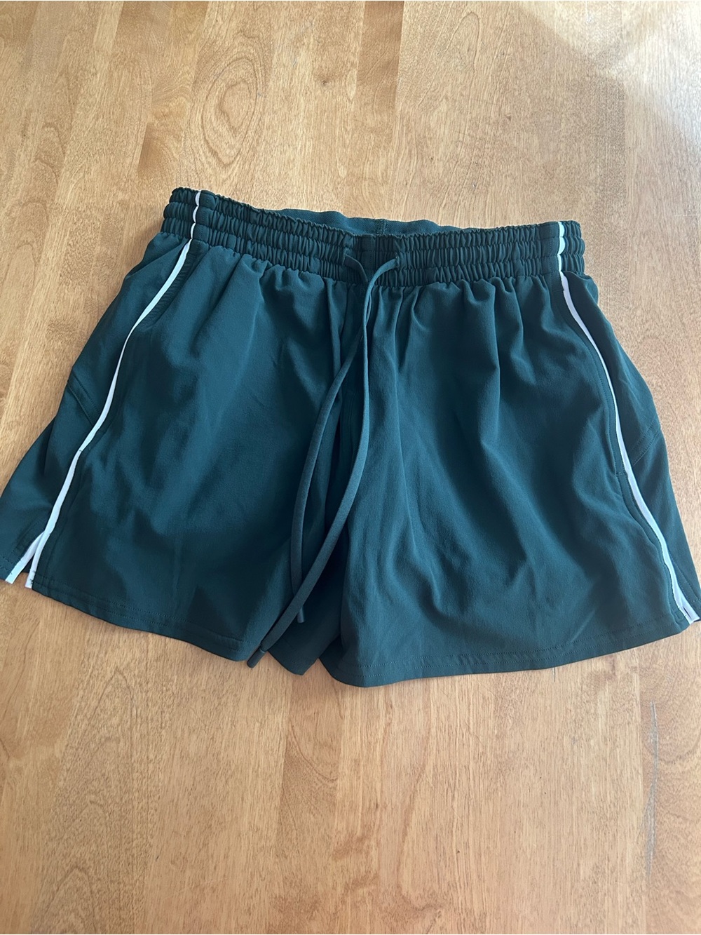 lululemon athletica dark green athletic shorts with white trim 4